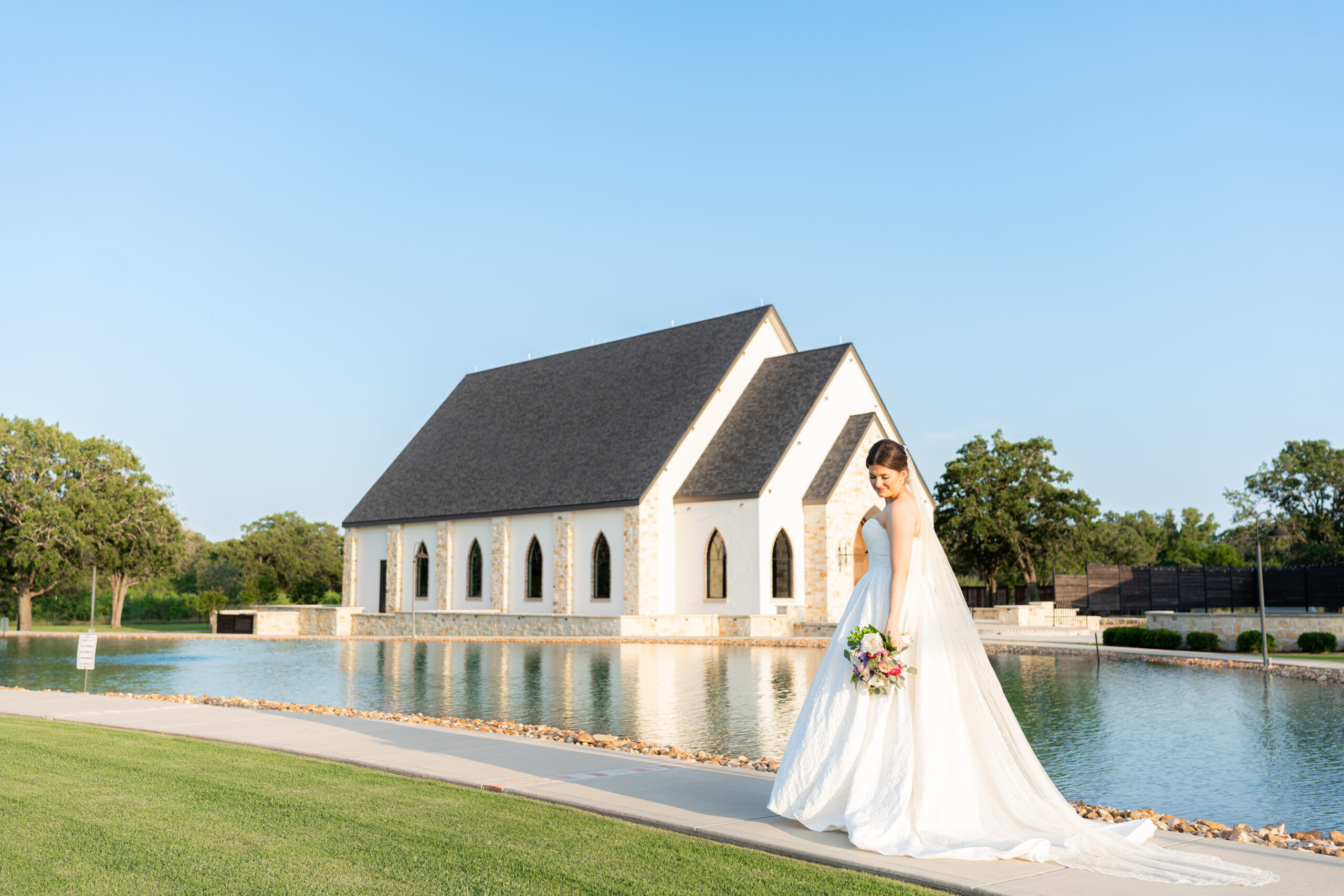 Lexie Foster in wedding dress near chapel